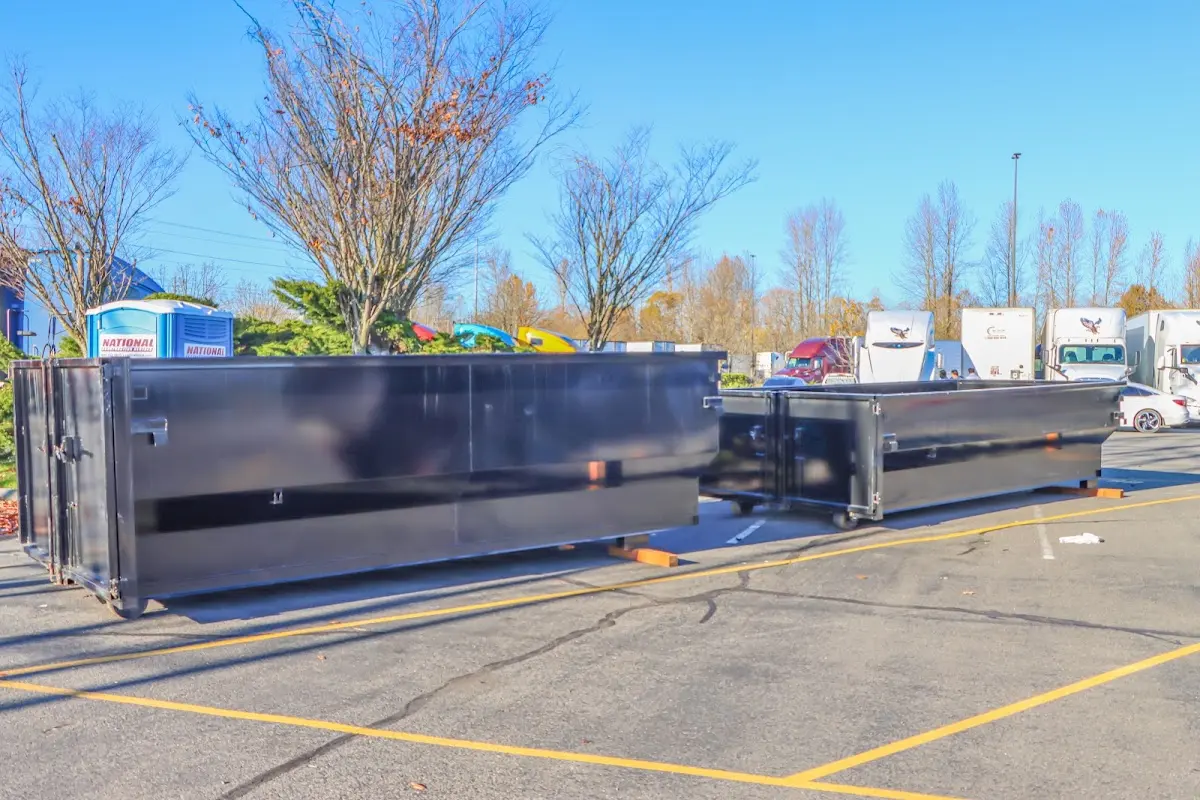 Professional dumpster rental service with roll-off container on residential driveway in Colusa